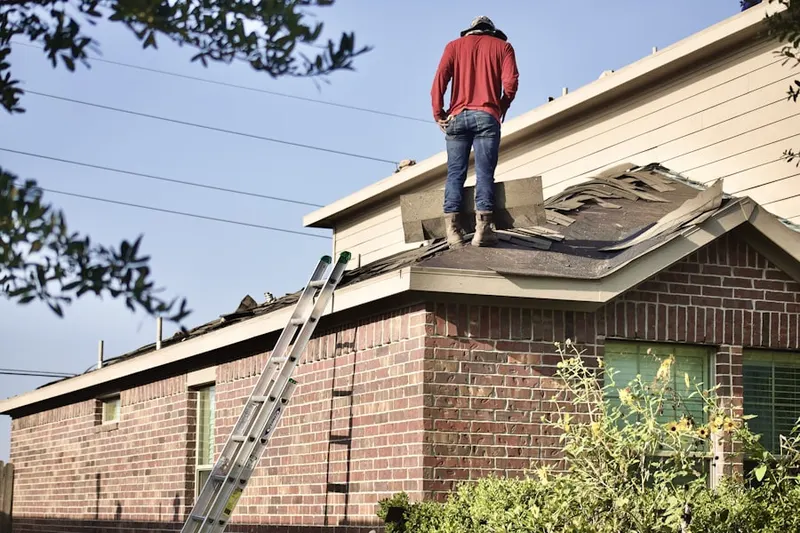 Professional roofer working on a residential roof in East New Castle
